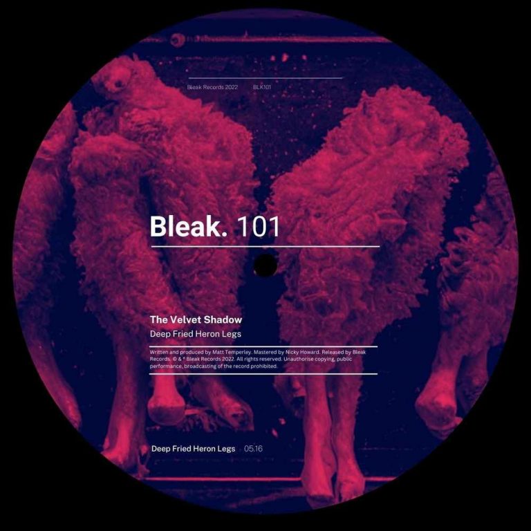 Displayed is a vinyl record featuring a surreal illustration of deep fried heron legs, all rendered in a striking purple hue. The label prominently lists "Bleak. 101" as the record label and highlights one track named "The Velvet Shadow - Deep Fried Heron Legs".