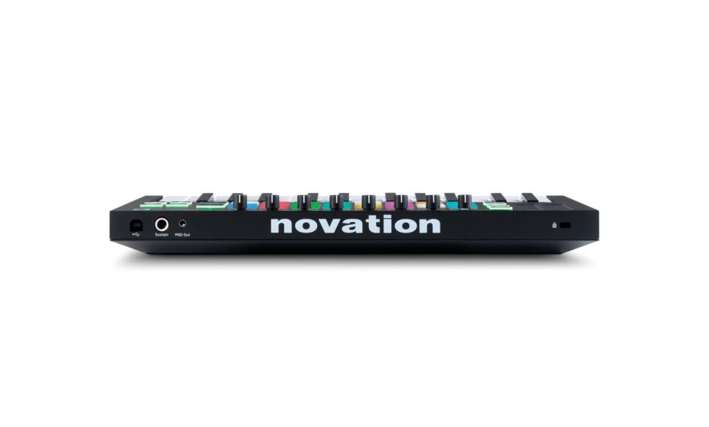 A black Novation launchpad mini keyboard featuring colorful dials and buttons on its top surface. The word "novation" is prominently displayed in white letters on the front of the device. Various input and output ports, including a headphone jack, are visible on the back.