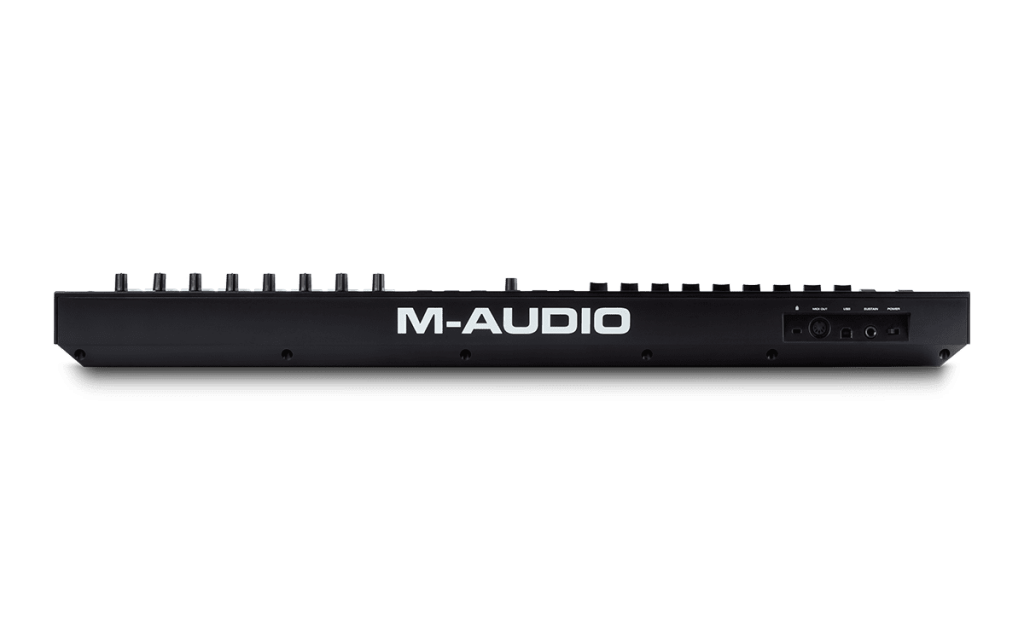 The rear view of an M-AUDIO Oxygen 49 Pro keyboard controller reveals multiple control knobs alongside connections for power, USB, MIDI, and other ports. Prominently displayed in large white letters is the M-AUDIO logo, clearly indicating the brand.